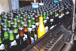 The yellow 'Smart Bottle' is conveyed on bottling lines to measure vibration and impact from the bottle's perspective.
