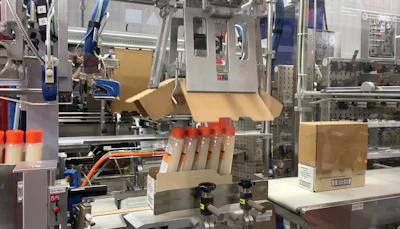 Closeup photo shows the corrugated lid being applied to a retail-ready case.