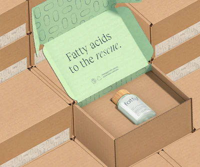 The inside of the corrugated shipper is laminated with a printed top sheet that conveys the upbeat, quippy brand messaging. Stacked shippers illustrate how little space is wasted in this packaging system.