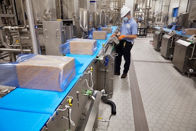 40-lb blocks of cheese move to Mettler Toledo metal detectors before secondary packaging.