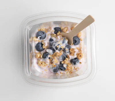 Beyond traditional retail requirements, both convenience store and airline customers—key target markets for these berry parfaits—required these packs to include a wooden spoon in the overhead space, which rests alongside the flow-wrapped granola.
