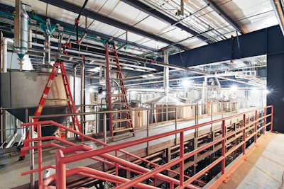 A mezzanine view of the 100-hL CombiCube brewhouse shows the included energy recovery system, which recovers steam energy from the boiling wort and gives it back as hot water to use for cleaning or the next batch of beer.
