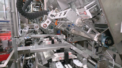 The 2D carton blanks reside in magazines oriented lengthwise, then pivot 90 deg during erecting to enter the flights widthwise, with both tuck tab flaps facing downward.