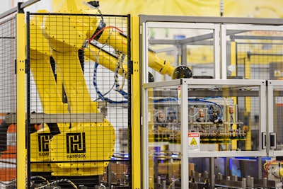 A dual-robot case packing cell being staged to run 1,000 cans per minute