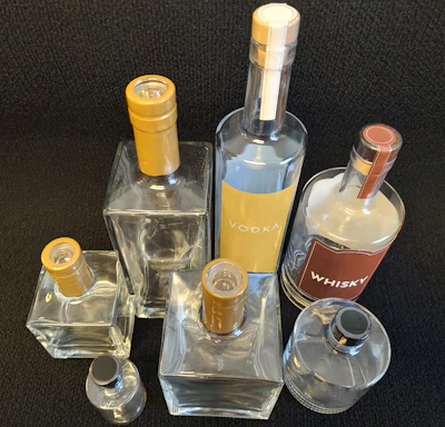 Deitz Co.&rsquo;s Pharmafill NB1 neck banding machine can apply TE bands and printed sleeve labels onto wine bottles, liquor bottles, and other tall bottles or bottles with long necks.