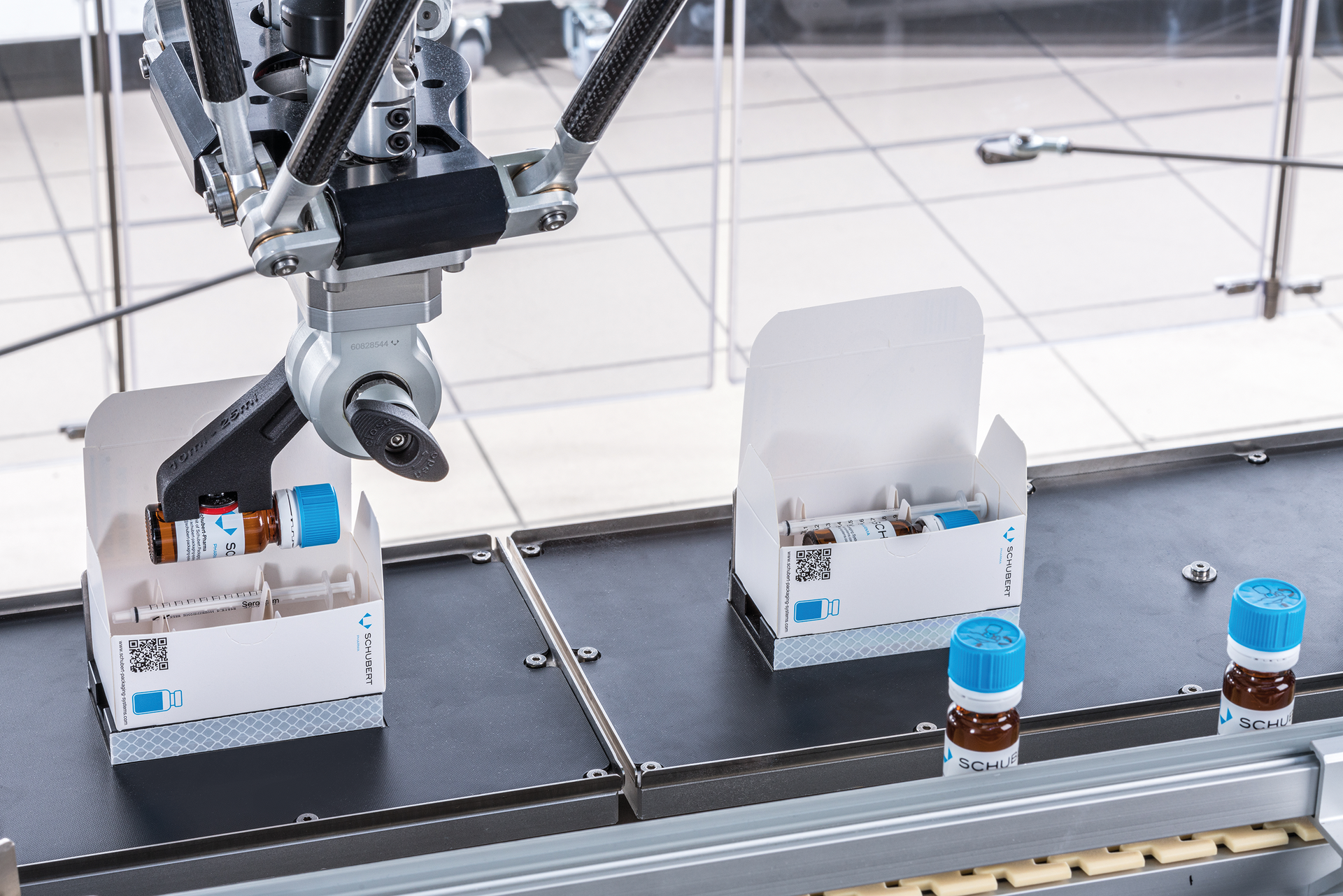 Labeled vials are loaded into cartons.