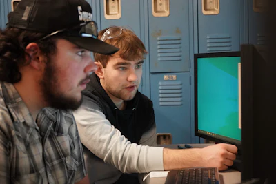 Cody Byrd, mechanical engineer at Hoosier Feeder Company, working with a student.