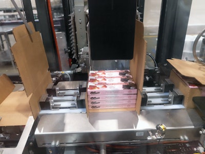 Cartons undergo a 90-deg turn and are oriented to travel wide-side first into case packaging operations. Once a 3 x 4 stacked format is collected, the block of cartons is pushed into postion in the wrap-around case packer. Adhesive is then applied ahead of palletizing.