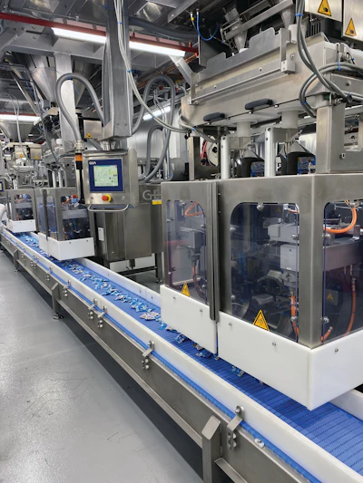 Shown here are three of the eight twin-bagger discharge stations that deposit 0.8-oz bags of gummies onto the conveyor that carries them to a cartoning operation.