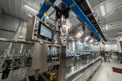 Shown here are bottles as they enter the monoblock rinser/filler/closer.