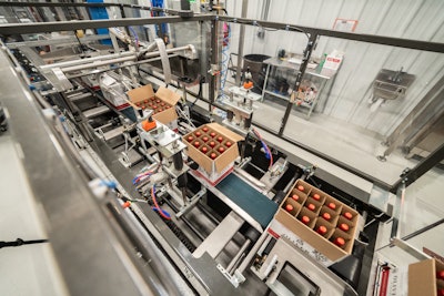 Near the end of the line the filled corrugated reshippers enter a machine that cuts the tabs holding the flaps down, folds the flaps, and tapes the cases shut.