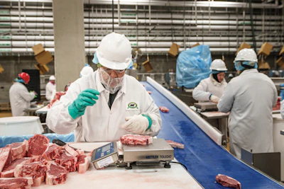 Though more technologies are being introduced to automate some tasks, steaks are still weighed and trimmed by hand to ensure quality.