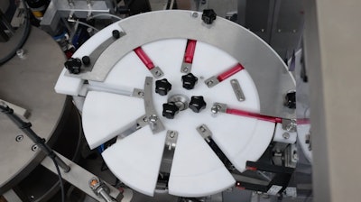 A starwheel orients tubes for filling.