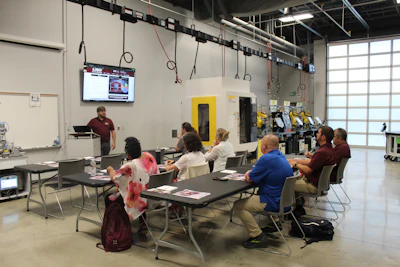 CTE instructors from various high school programs get hands-on training with advanced manufacturing technologies at an AiM UP training lab.