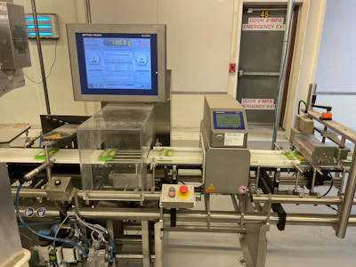 Filled cartons run through this combination checkweigher and metal detector , which also communicates with the volumetric filler’s controller to improve filling accuracy.