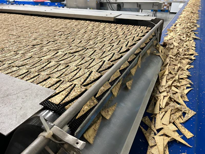 Flatbread pieces exit the 48-in.-wide Spectrum Oven and head for packaging.