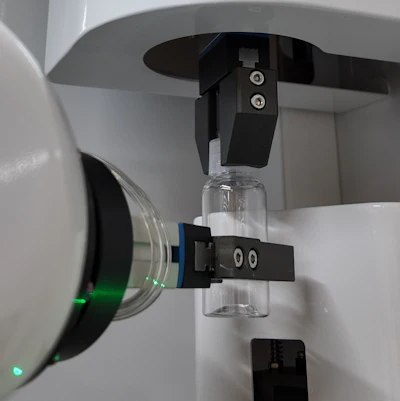 Caps are torqued off prior to filling, then on after filling in a capping chuck module.