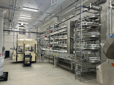 Assembled ice cream cartons gather on a Dyco Inc. staging area, before moving down to filling through a drop chute.