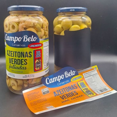 The top label layer contains legal and branding information and can be easily peeled off, revealing a reusable black surface beneath that resembles a chalkboard.