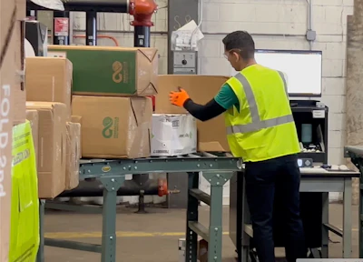 The facility receives from 500 to 1,000 parcels per day that are each weighed, scanned, and grouped into material categories before the contents of the boxes are sorted.