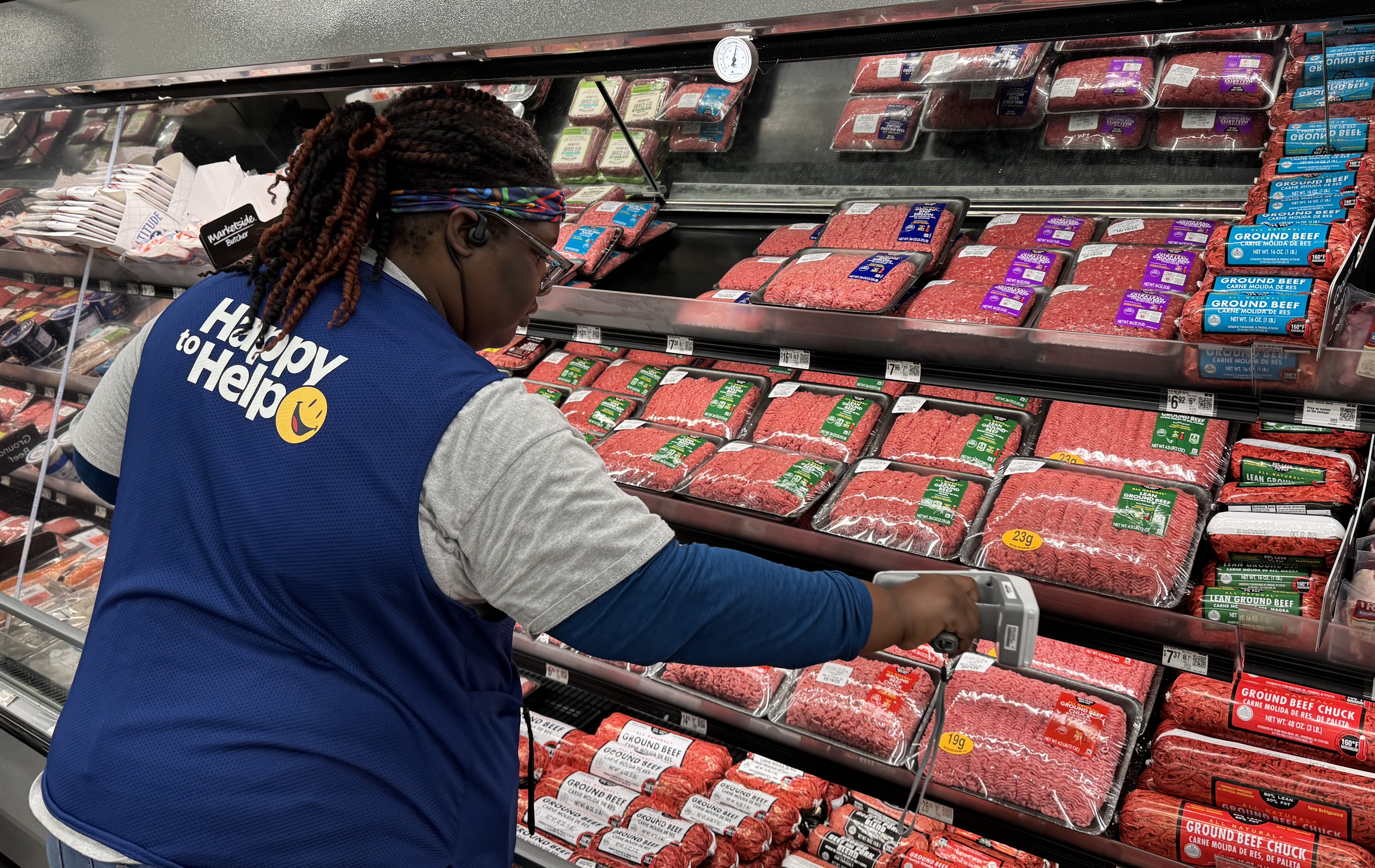 Walmart associate scans fresh meat products tagged with RFID-enabled labels.