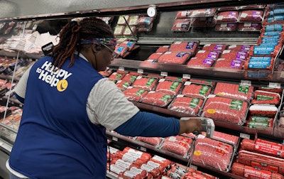 Walmart associate scans fresh meat products tagged with RFID-enabled labels.